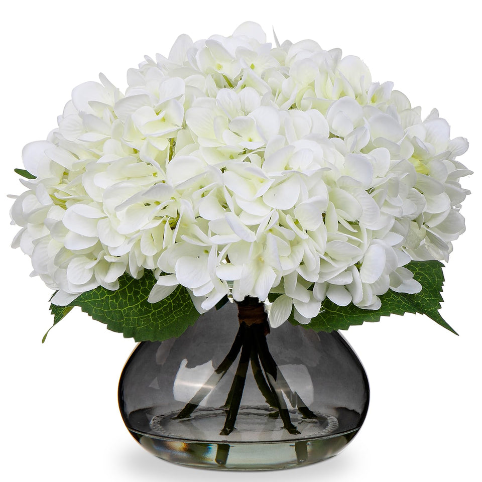 Hollyone hydrangea with glass vase showcases lifelike blooms for an elegant tablescape.
