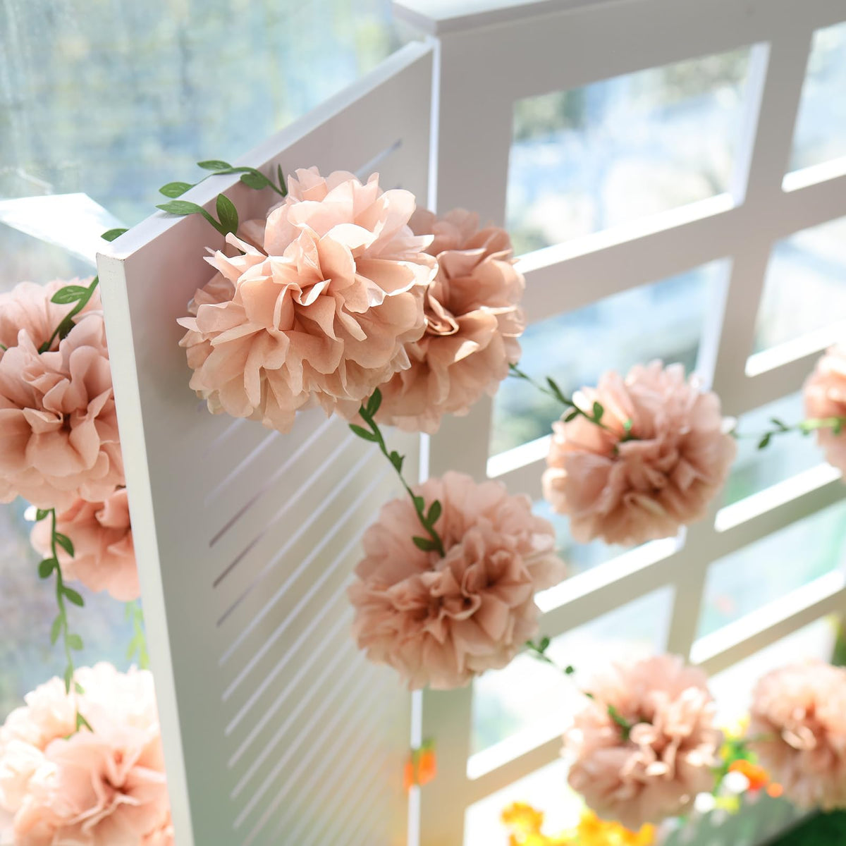 Homarkable pink tissue pom-pom garland assembled as wedding backdrop adds festive charm
