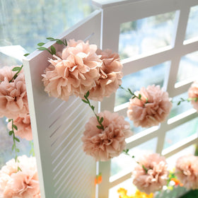 Homarkable pink tissue pom-pom garland assembled as wedding backdrop adds festive charm