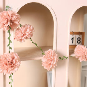 Homarkable pink tissue pom-pom garland above the room elevates spring celebrations