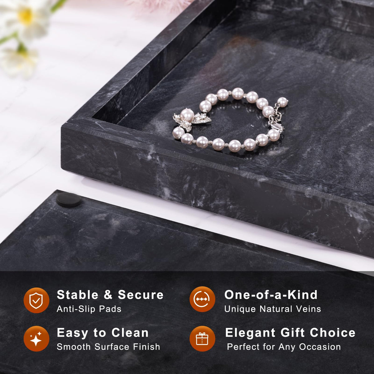 Homaura marble tray with distinctive veins highlights perfume or jewelry display.