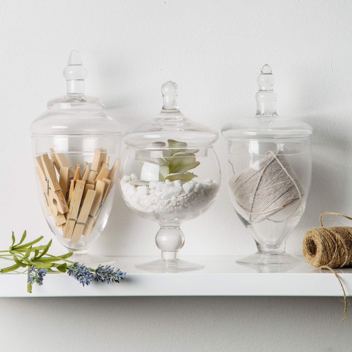 Home Essentials & Beyond clear glass jars with round lid handle for easy access.