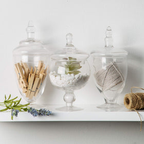 Home Essentials & Beyond clear glass jars with round lid handle for easy access.