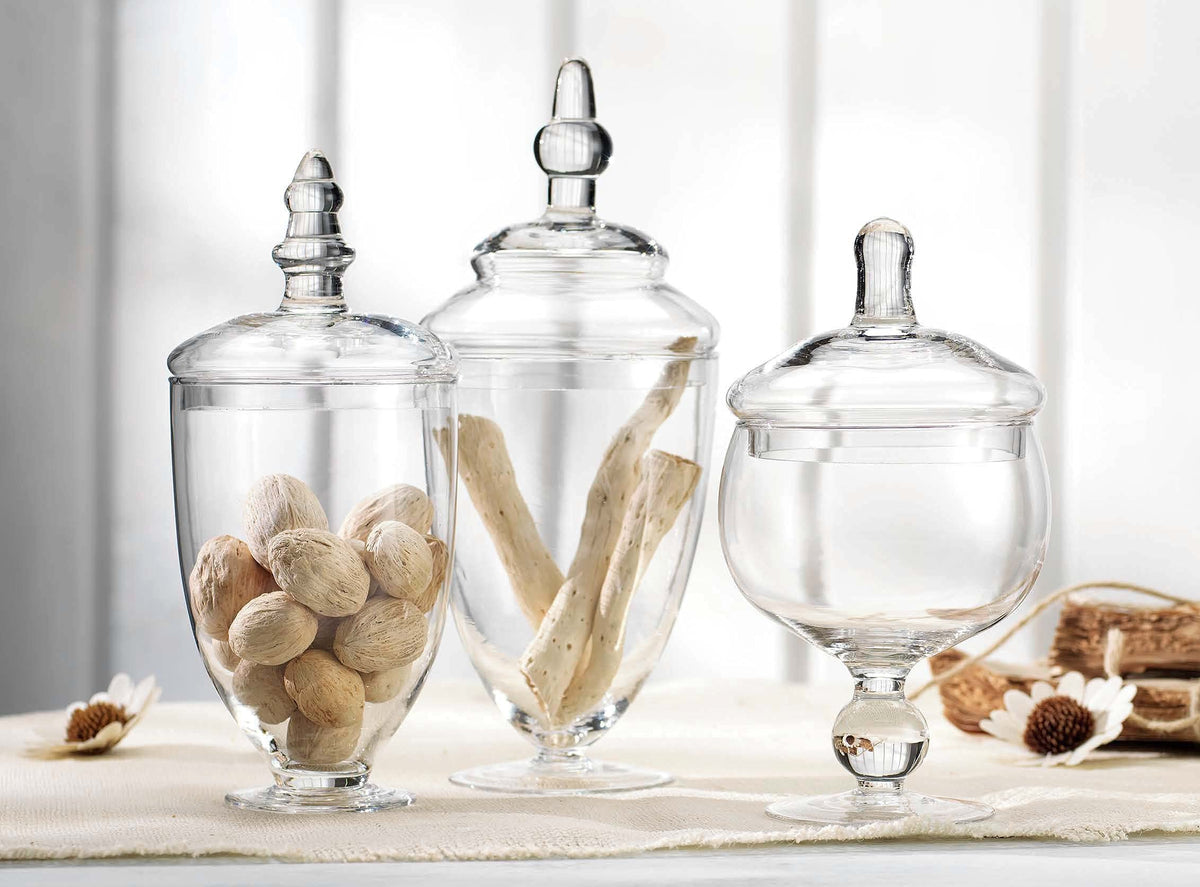 Home Essentials & Beyond footed glass canisters ideal for bathroom storage and organization.