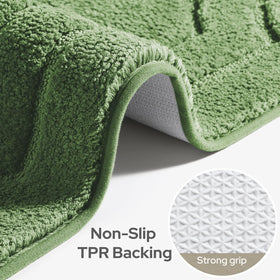HOMEIDEAS microfiber texture close-up on sage green rug highlights absorbent fibers.