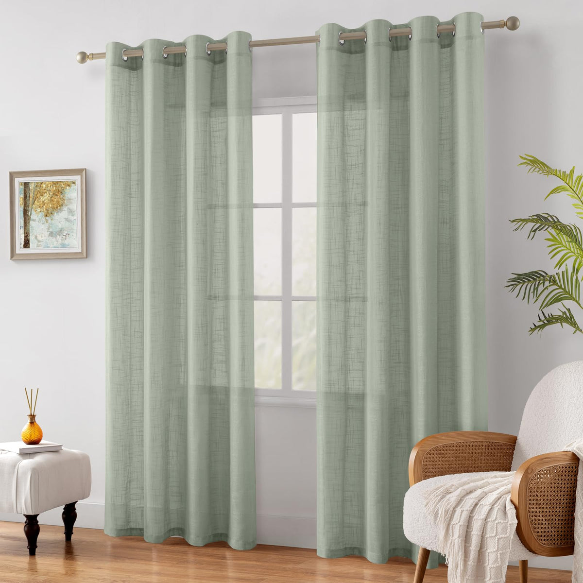 HOMEIDEAS sage green linen-textured sheer curtains draped in a dining room.