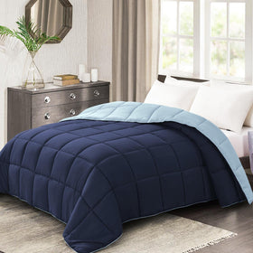 Homelike Moment twin comforter in navy on bed showing reversible design.