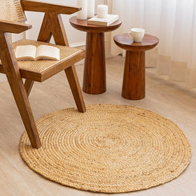 Homemonde three-foot round jute rug in natural color complements diverse decors.