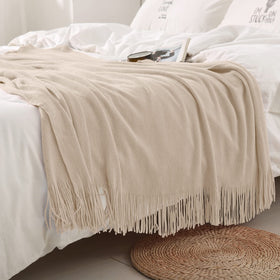 Homiest knit throw fringe detail shows soft acrylic fiber and tassels.