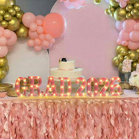 Honoson Grad 2026 pink LED sign used as a table centerpiece.