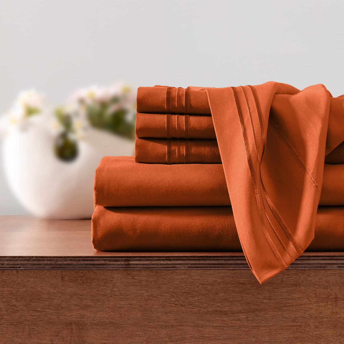 Horbaunal burnt orange bedroom setup demonstrates cozy, wrinkle-resistant bedding