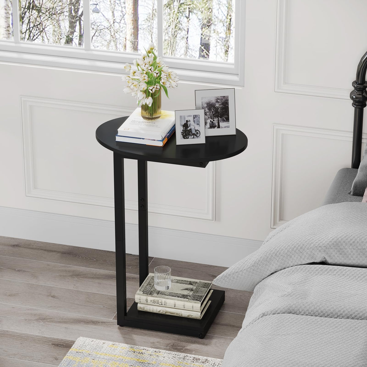 Hosfais C-shaped end table with matte black finish beside a sofa