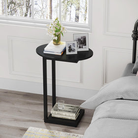 Hosfais C-shaped end table with matte black finish beside a sofa