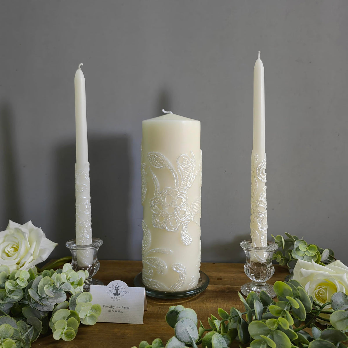 Hosley cream taper left candle provides warm ambient lighting for reception tables