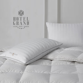 Hotel Grand pillows arranged on bed illustrate versatile night-long support for multiple sleep positions.