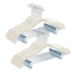 House Day velvet hangers with adjustable clips holding complete outfits securely.
