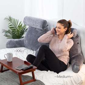 Husband Pillow XXL watching TV in bed with ergonomic positioning
