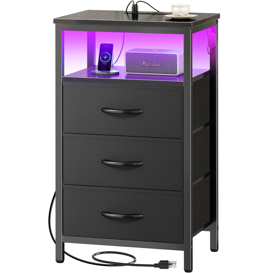 Huuger night stand with charging station beside the bed offering multiple ports.