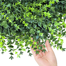 HUZIYAHAN boxwood wreath enhances living room decor with soft greens.