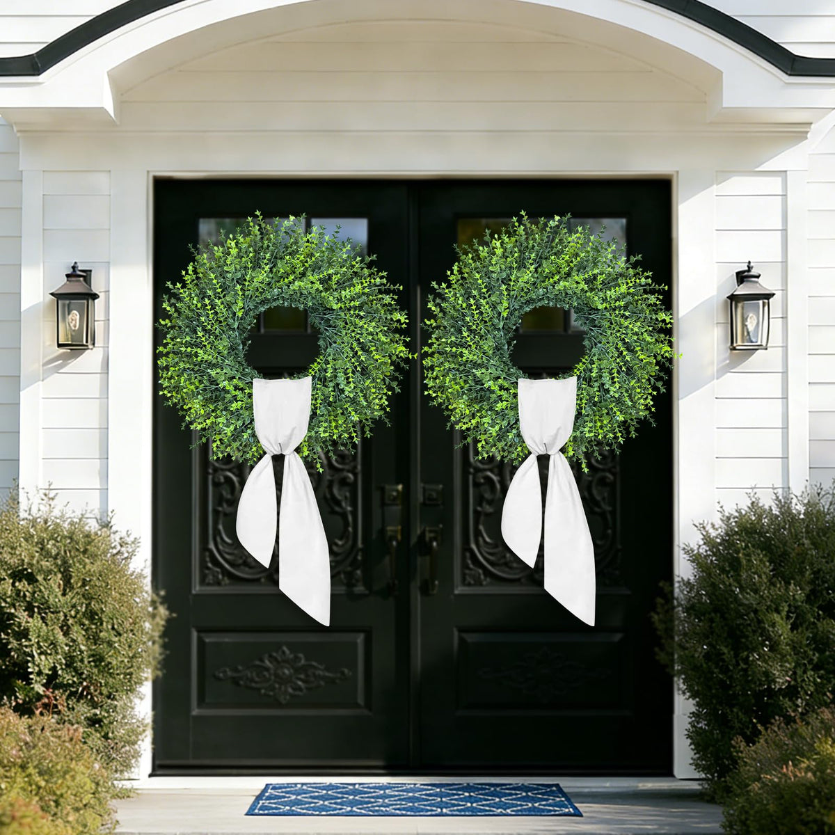 Outdoor-ready boxwood wreath with grapevine base enhances curb appeal and texture.