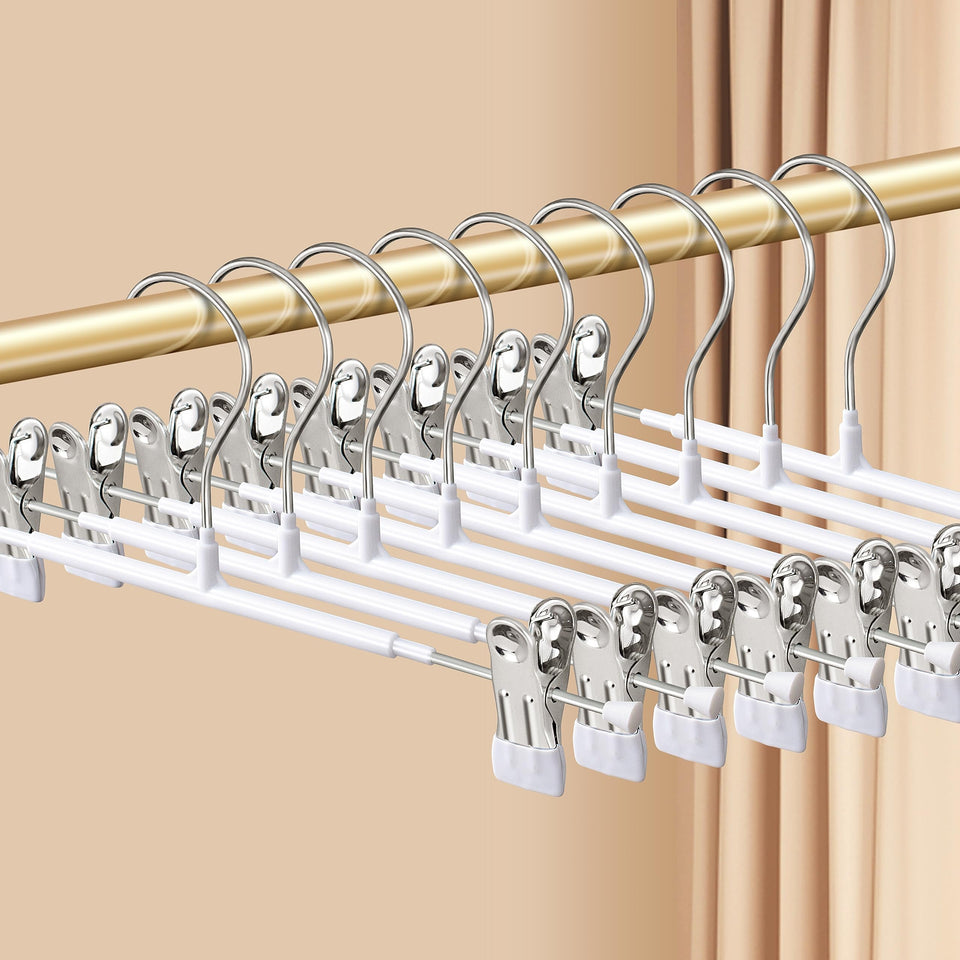 HWAJAN pants hangers with clips secure trousers with a non-slip grip in a tidy closet.