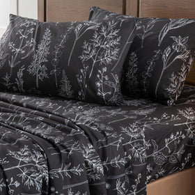 Bedroom scene highlights deep-pocket fit and breathable, smooth texture.