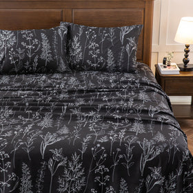 HYPREST bed draped in grey and black floral sheets adds chic ambiance