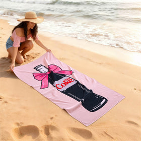 Idea Nuova 30x60 towel shown laid out for beach lounging and sunbathing.