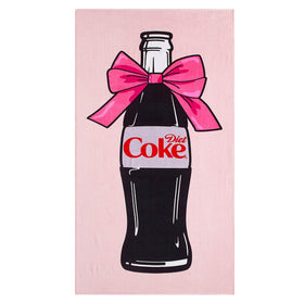 Idea Nuova Diet Coke bottle bow towel on pink backdrop for beachfront lounging.