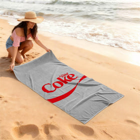 Idea Nuova Diet Coke towel shows 30x60 size for generous full-body coverage.