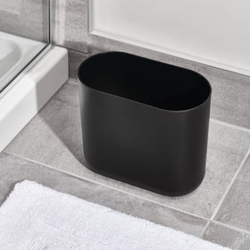 iDesign Cade Oval Trash Can’s black finish adds a modern touch to any small room.