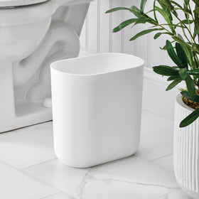 iDesign Cade trash can in a bathroom with a clean white finish