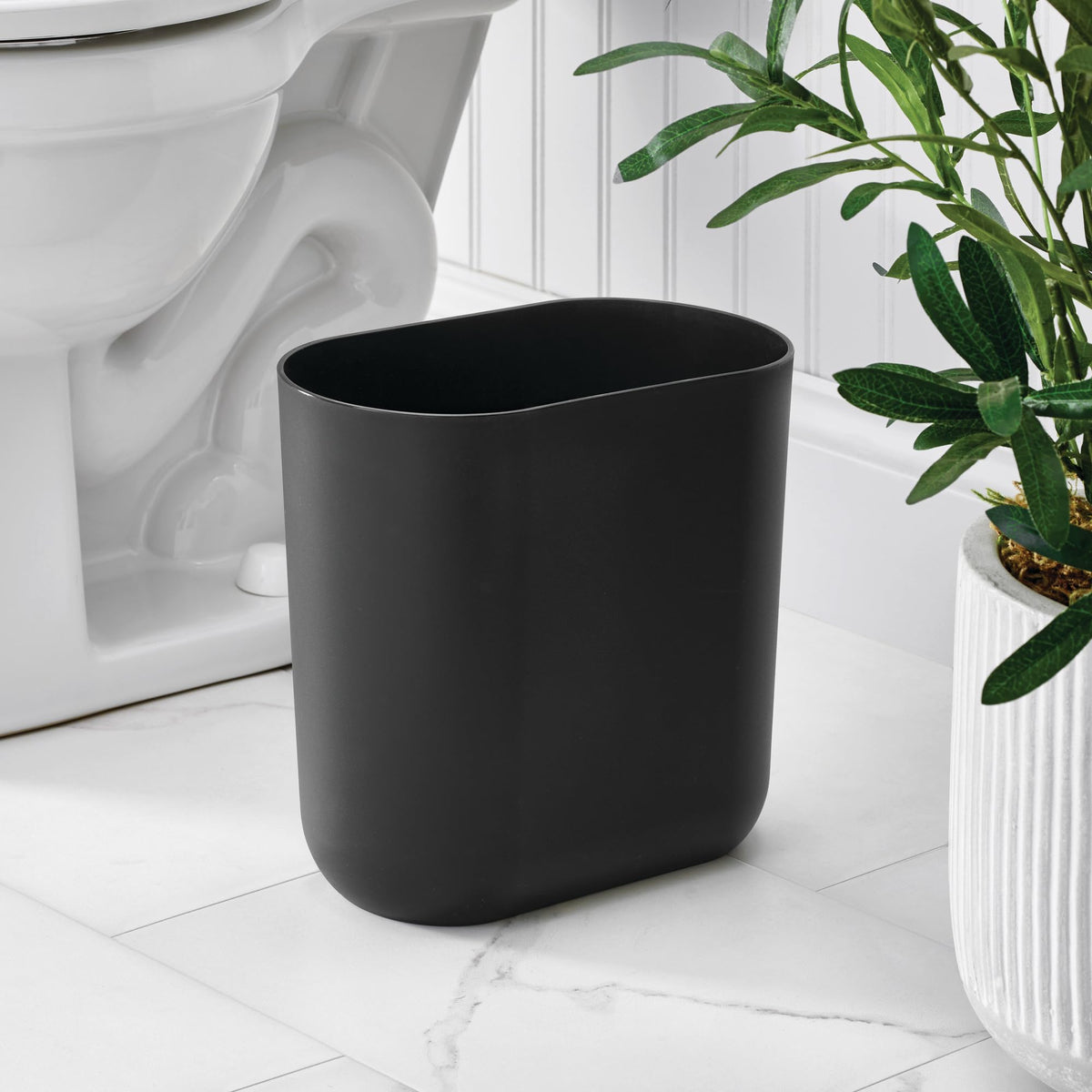 iDesign Cade Oval Trash Can’s slim silhouette complements bathrooms and vanities without crowding counters.
