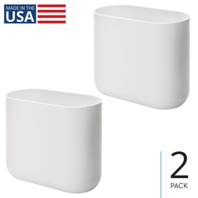 iDesign Cade oval trash can placed under a desk for discreet waste