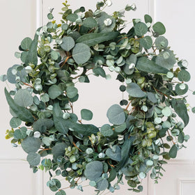Idyllic 22-inch eucalyptus wreath on front door for year-round curb appeal.