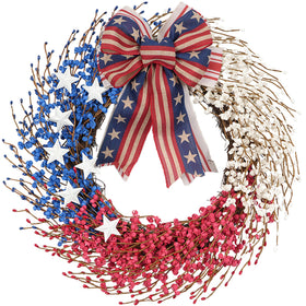 Idyllic 22-inch patriotic wreath on front door featuring bold red white blue ribbons and stars