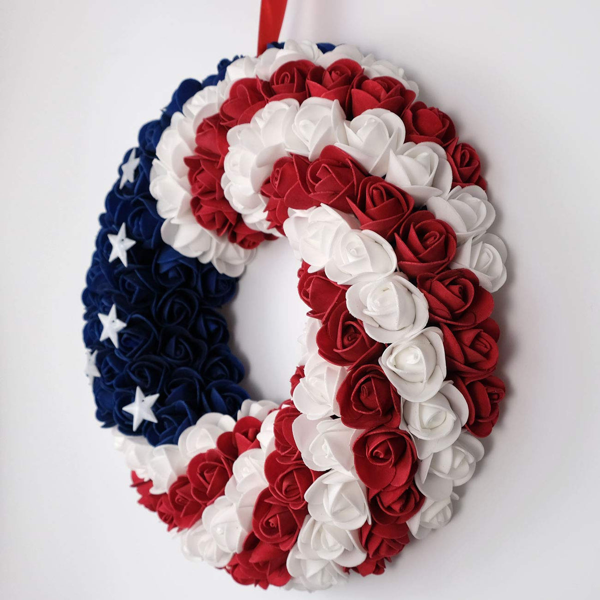 Idyllic americana wreath on wall complements blue-red-white theme.