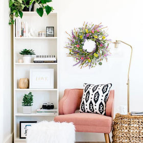 Idyllic daisy wreath on door creates a vibrant seasonal display.