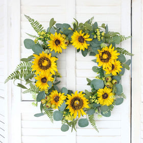 Outdoor wedding setting featuring the Idyllic sunflower wreath centerpiece.