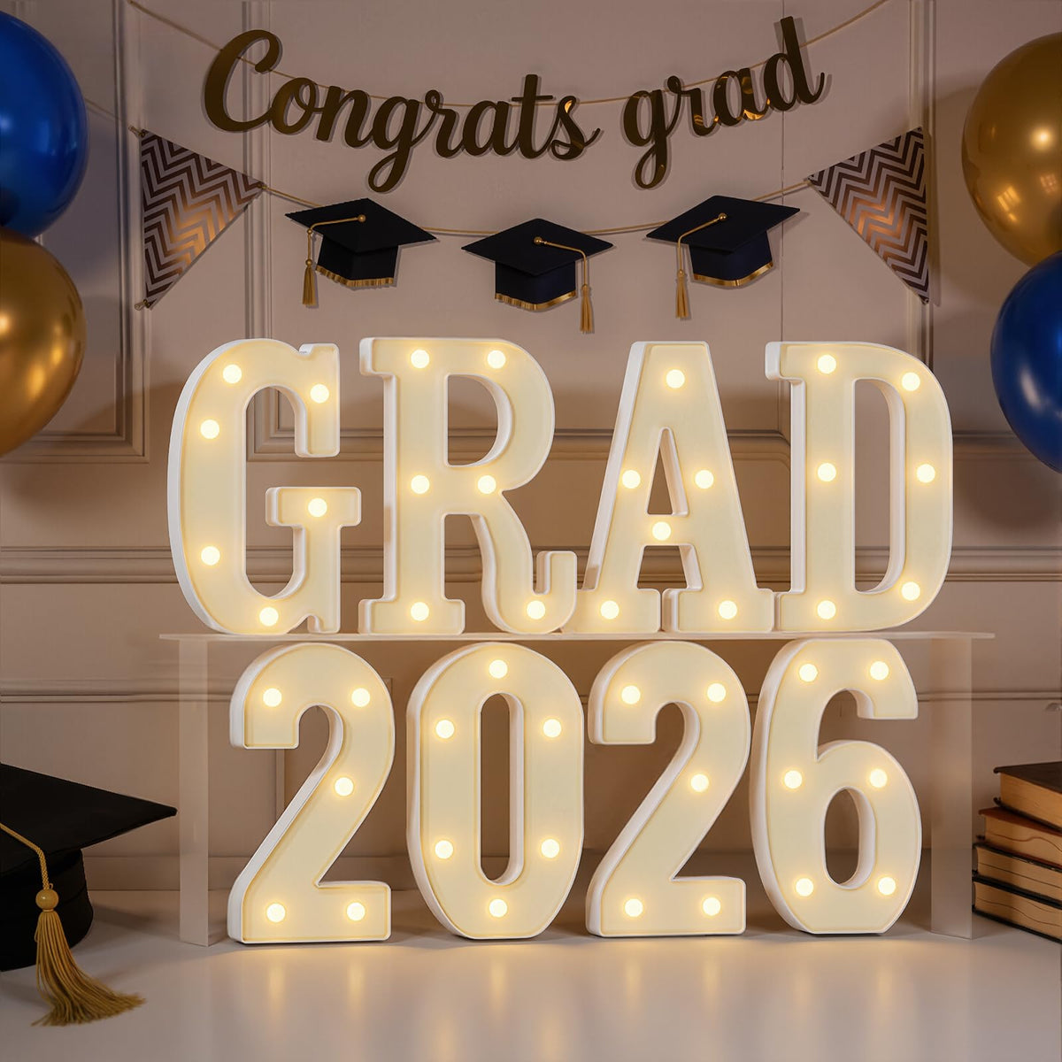 Imprsv GRAD 2026 letters illuminate a stylish graduation centerpiece with warm glow for photos.