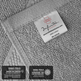 Infinitee Xclusives gray hand towels care label shows machine-washable convenience.