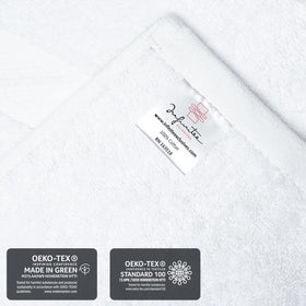 Infinitee Xclusives white towels in a clean bathroom setup