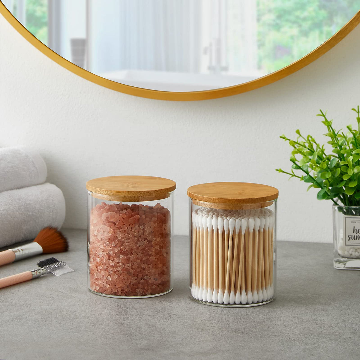 Compact INIUNIK bathroom storage setup with four glass jars