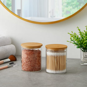 Compact INIUNIK bathroom storage setup with four glass jars