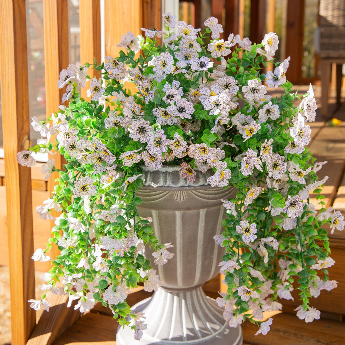 INSPRING daisy trailing vines in an urn planter for a welcoming focal point