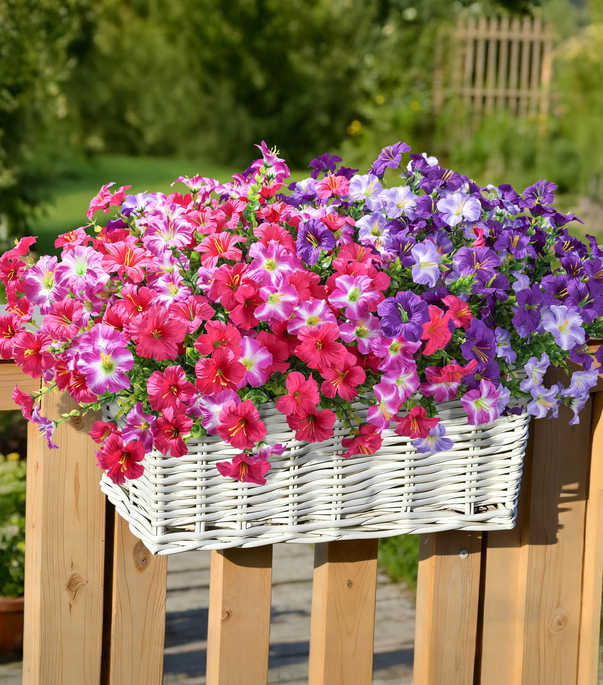 INSPRING petunias and eucalyptus arrangement in a sunny balcony planter