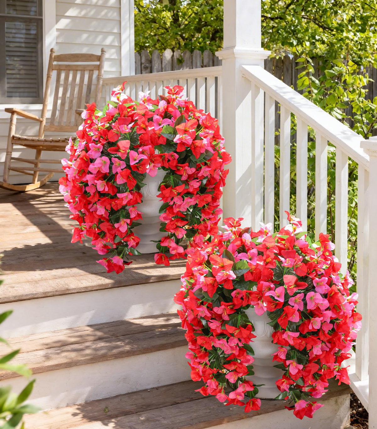 INSPRING faux bougainvillea trailing vines in an urn planter elevate curb appeal.