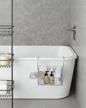 IntreLife shower caddy hanging by the tub helps manage bath supplies.