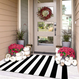 IOHOUZE black white striped rug on a front porch adds timeless curb appeal