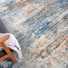 IOHOUZE entryway rug placed on floor with blue rust pattern.